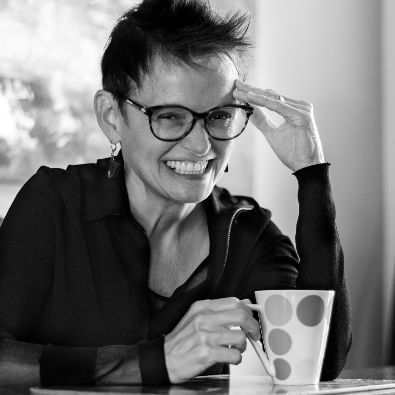 black and white image of a women holding a coffee